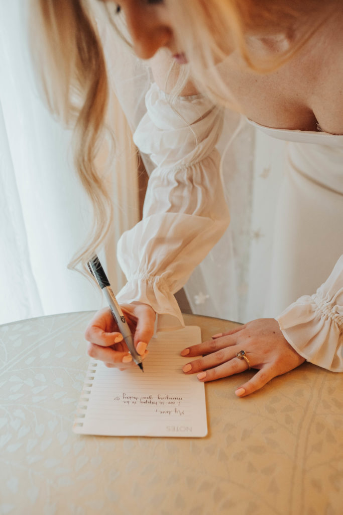 Columbus Georgia photographer captures bride writing groom a love note on the day of the wedding