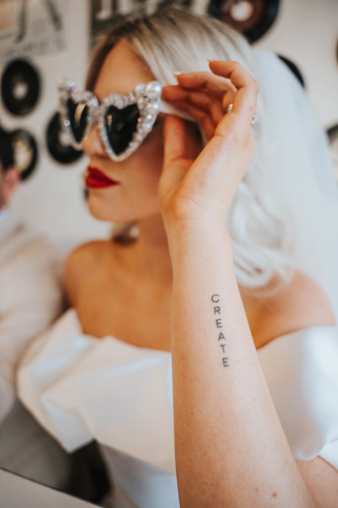 Bridal portrait with a black letter tattoo that says CREATE