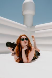 Self portrait - Wedding Photographer from Columbus Georgia with red hair sitting in a white bounce castle