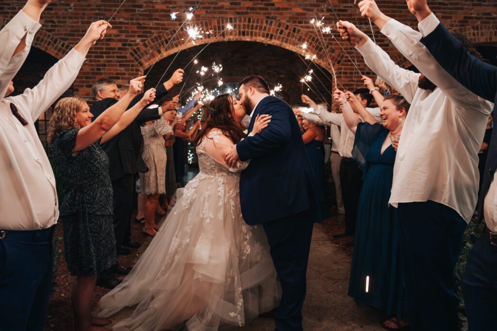 Bride and Groom kiss in sparkler exit at Blacksmith shop in Macon Georgia