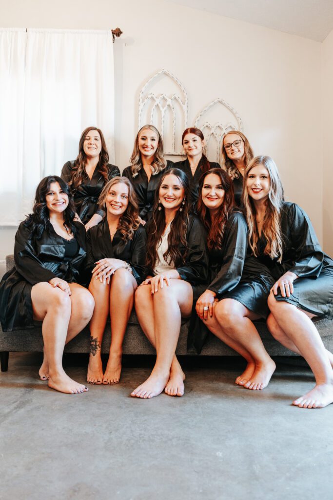 Bride and bridal party pose for photo in the bridal suite